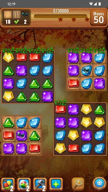 Two separate gem grids joined by a narrow bridge, fifty moves and a row of boosters below